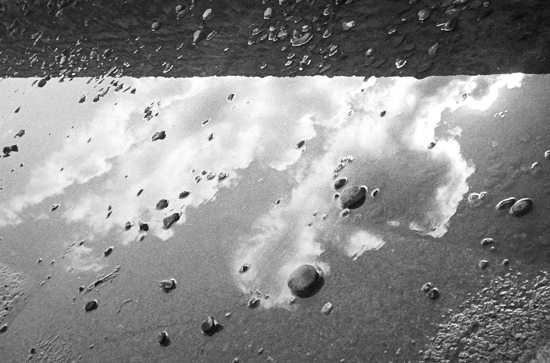 Clouds, stones, puddle and reflection, Brighton (UK)